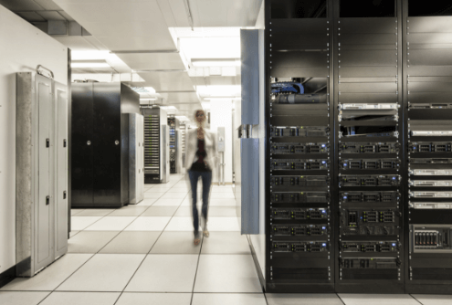 a person walking through islets of server machines